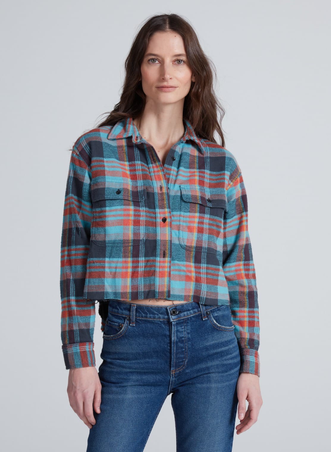 ASKK Crosby Hudson Plaid cropped flannel shirt in red and blue with blue jeans, casual style, light background.