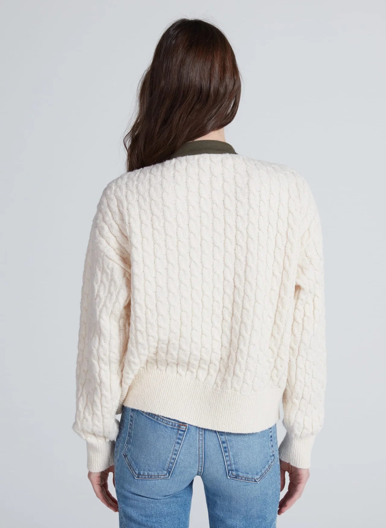 Cream knit Greenwich Cardigan by ASKK, seen from the back, styled with blue jeans for a relaxed look.