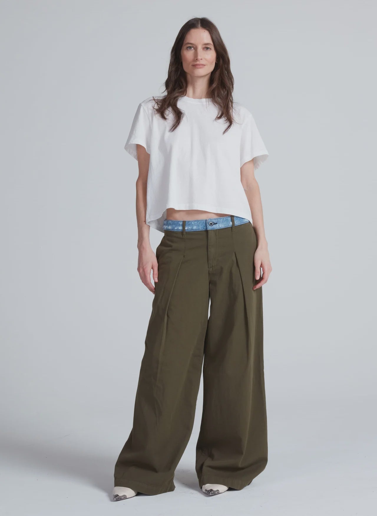 ASKK high-rise olive Greenwich Pant with denim waist, styled with a white crop tee and white shoes, modern casual look.