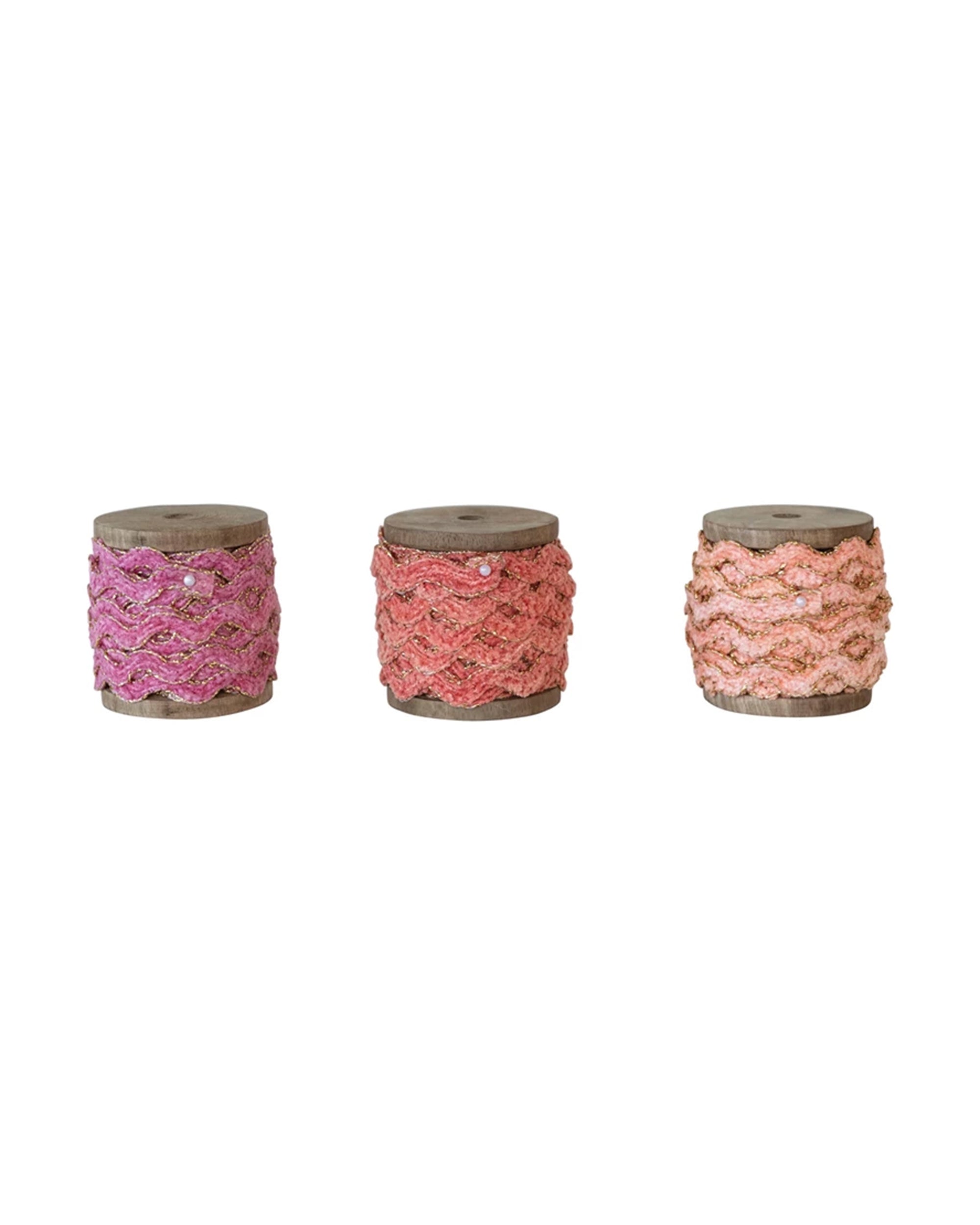 The Creative Co-op Chenille Ribbon Spool Assorted set features three wooden spools with pink, coral, and peach scalloped ribbons—ideal for gift wrapping or crafts.