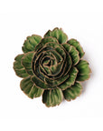 The Avocado Green Rozella Peony by Chive Ceramics (thru Faire) features thick, layered leaves with brownish edges in a rosette pattern, resembling a large ceramic flower, shown against a white background.