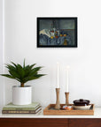 A minimalist interior displays a potted plant, stacked books, and wooden candlesticks on a tray. Above, Faire’s framed "Cezanne The Peppermint Bottle" limited-edition matte art print hangs on the white wall.