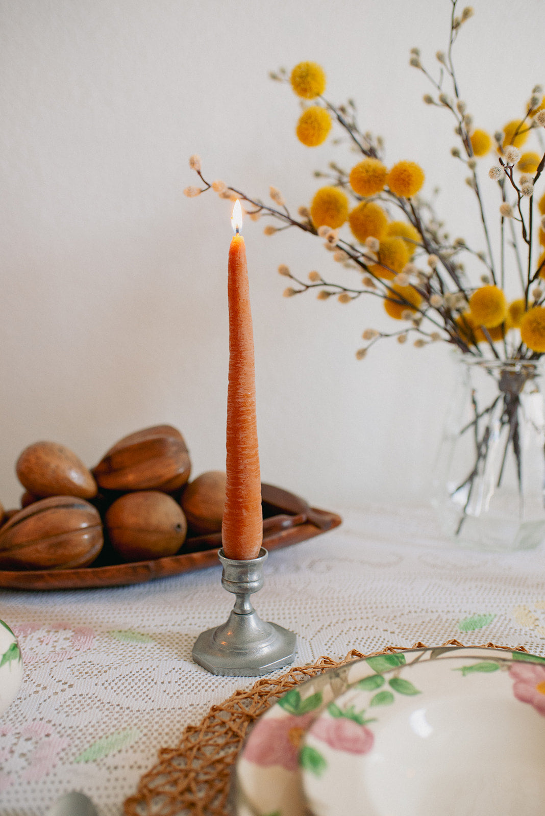 Faire’s Carrot Beeswax Candles are handmade and come in a candle holder.