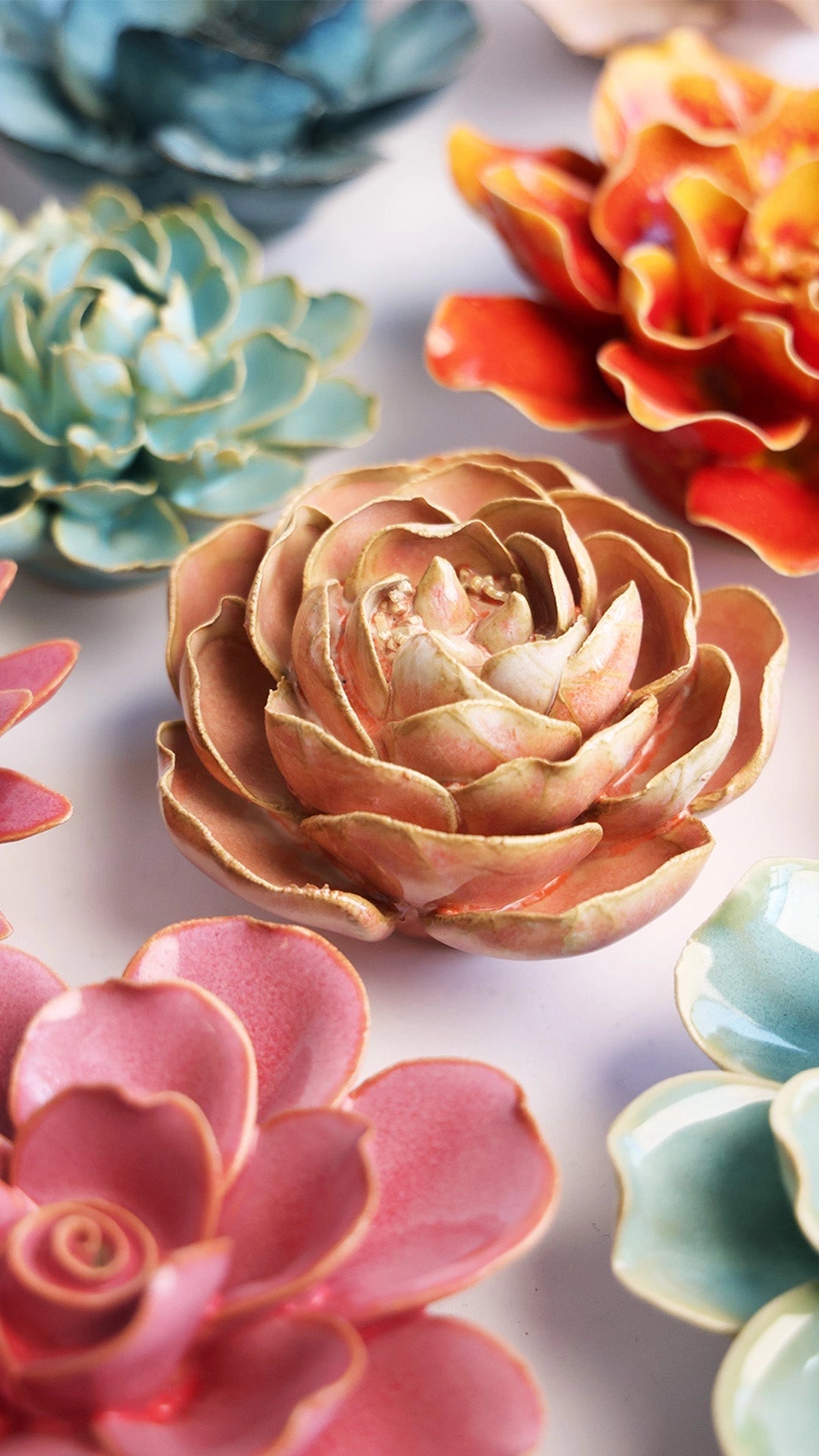 A close-up of the Peach Pink Peony by Chive Ceramics (thru Faire), a glossy ceramic succulent with intricate petals—perfect as a colorful, decorative accent for your tabletop or wall.
