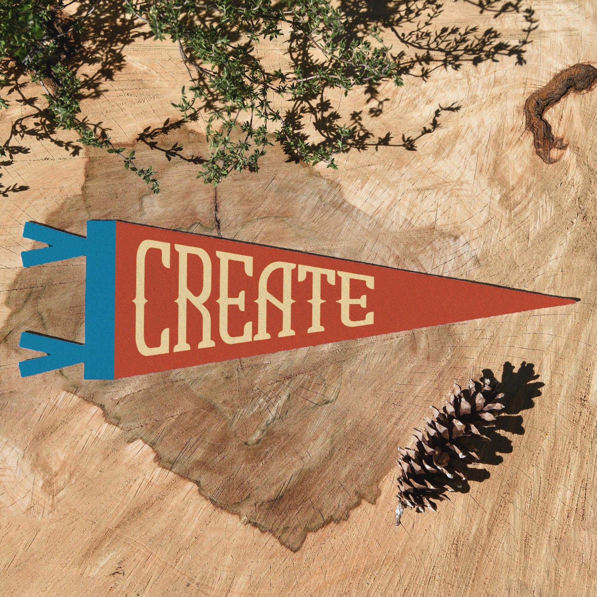 The "Create" Felt Pennant by Faire features a vintage triangular design and is perfect as creative room decor or a thoughtful gift for inspiring creativity.