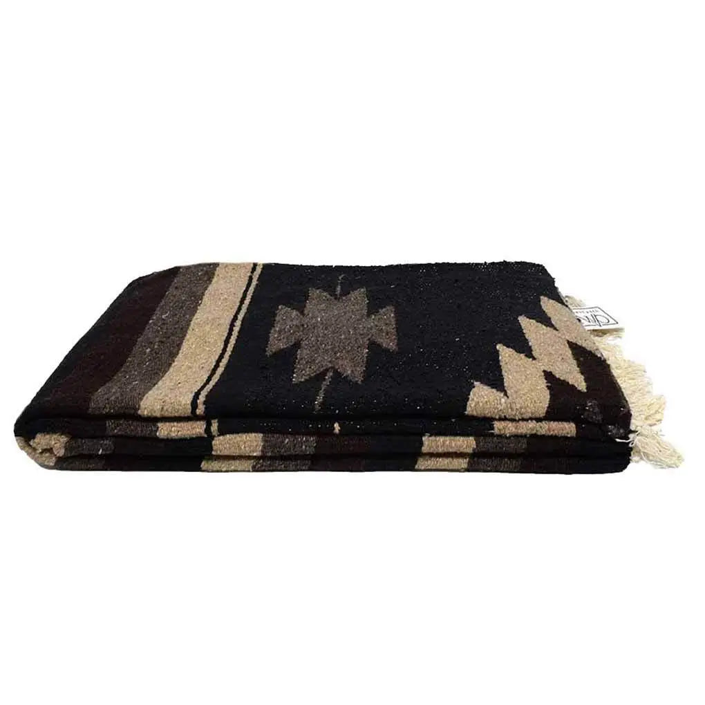 The Faire XL Mexican Diamond Blanket in brown and black features geometric patterns and fringed edges, inspired by classic designs, shown folded against a plain white background.