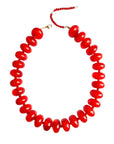 The Faire Bailey Chunky Beaded Necklace features large glossy red beads, a small gold clasp, and an adjustable extension chain for a bold statement look.