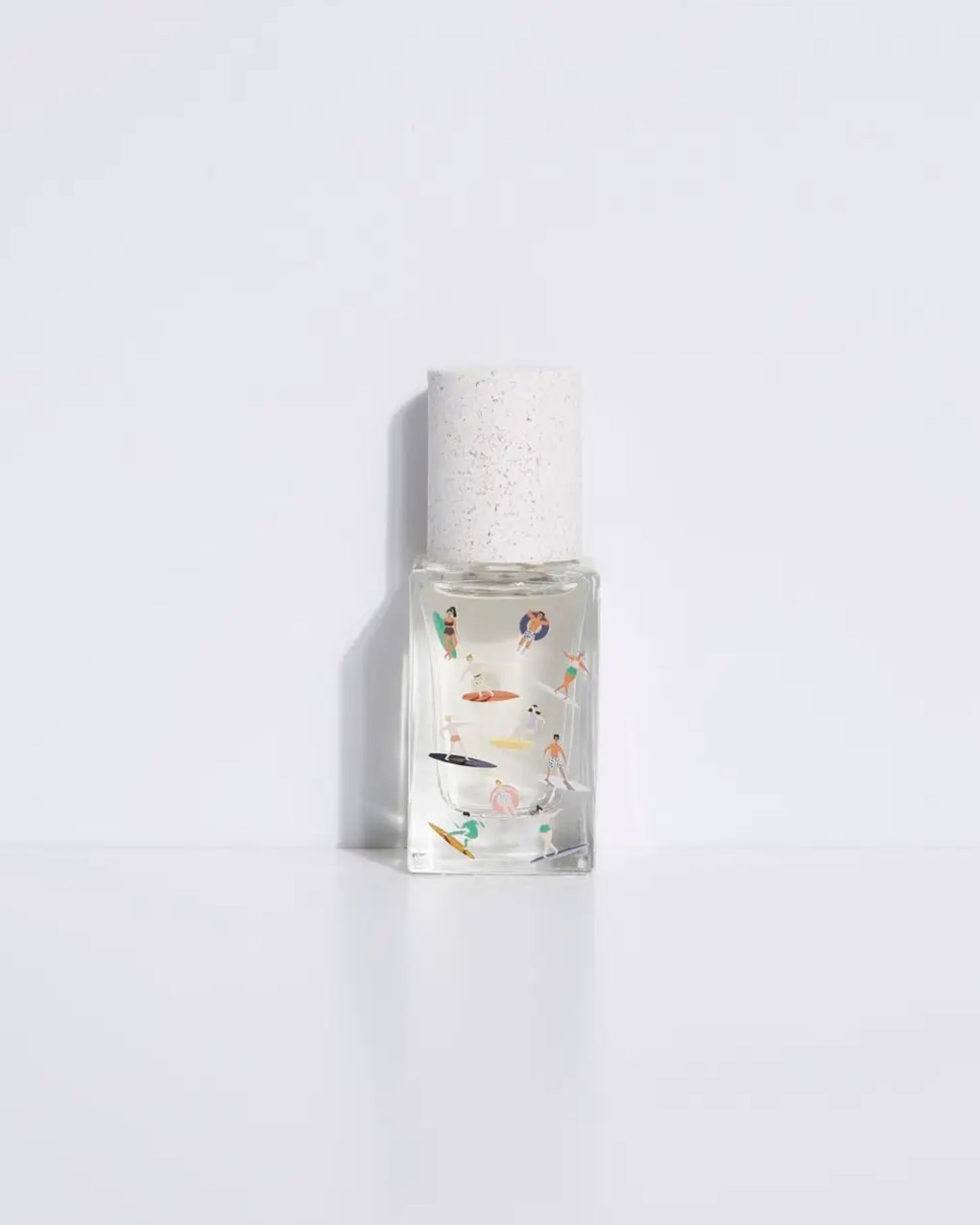 A Maison Matine Perfume by Faire, featuring a clear bottle with a white speckled cap and small colorful illustrations of people swimming and relaxing, set against a plain white background.