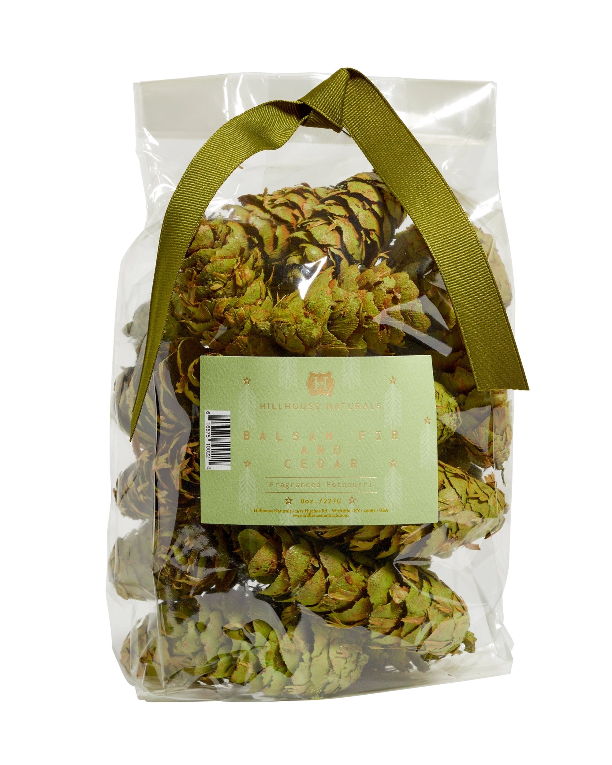 A clear plastic bag of Potpourri Pine Cones by Faire, featuring dried fir cones with cedar and pine notes, finished with an olive-green ribbon at the top.