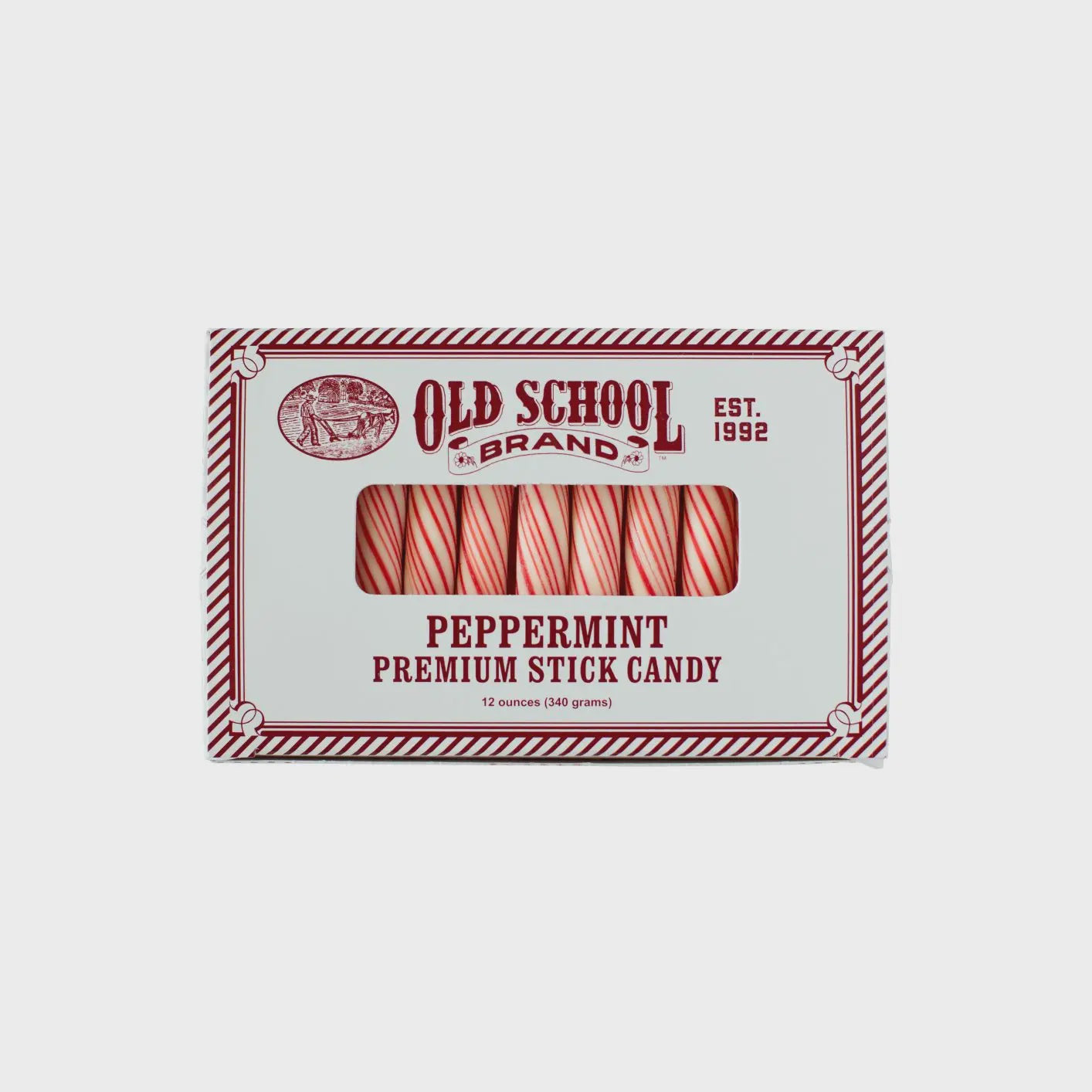 A nostalgic box of peppermint stick candy, containing 12 striped red and white sticks that melt in your mouth, is styled with vintage graphics under the brand established in 1992.