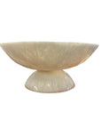 The BIDK Home White Resin Bowl 17.7" is a cream-colored, semi-translucent accent with a wide rim and rounded pedestal base; its modern design makes it an elegant centerpiece for any space, especially against a white background.