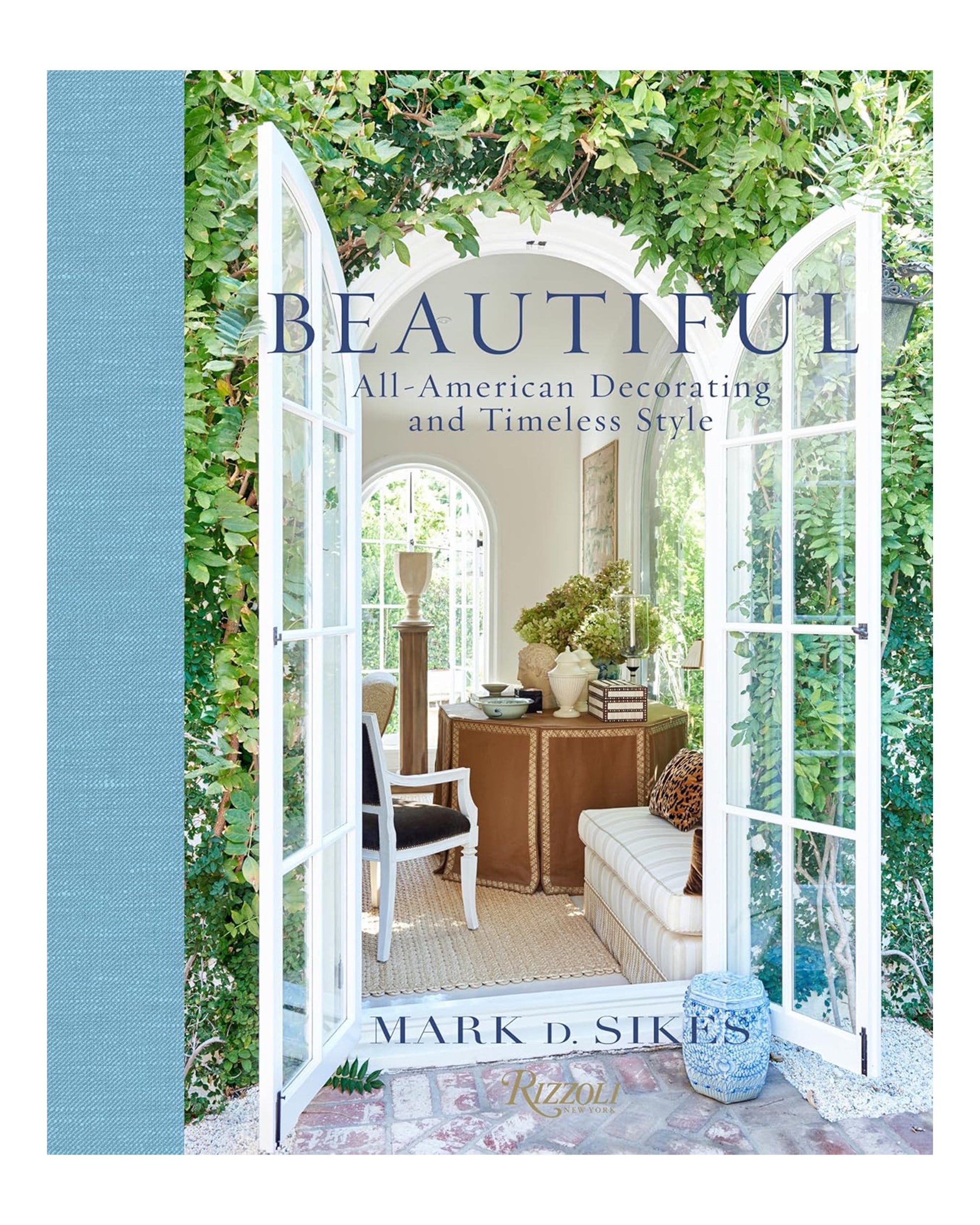 The cover of Random House’s "Beautiful By Mark D. Sikes" features open white French doors leading to a bright sitting area that embodies American style interiors and California-inspired indoor/outdoor living with lush greenery.