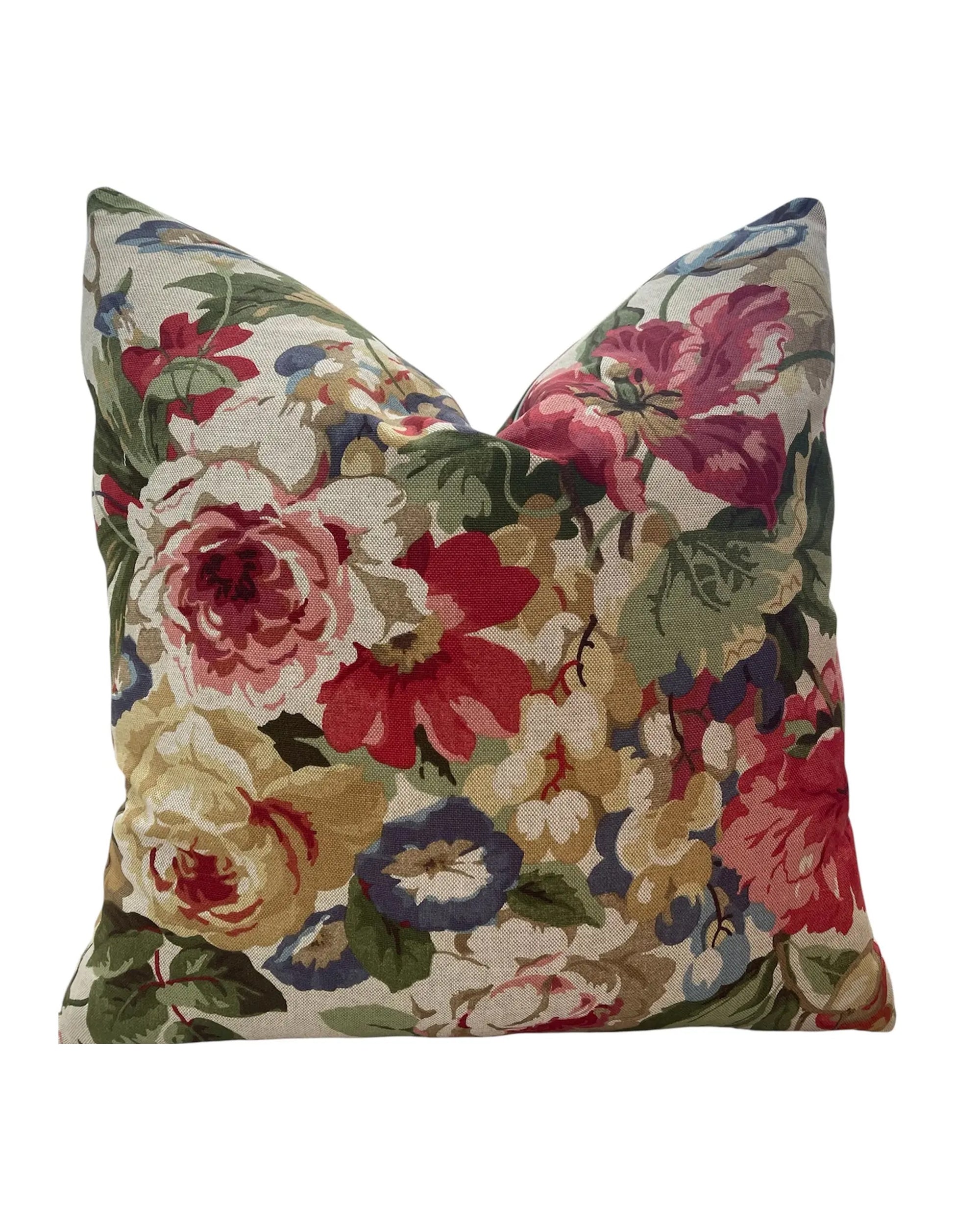 The Bernadette Floral 20x20 Pillow by Dahlia & Grace Pillows features a vibrant floral design in red, pink, yellow, and blue with green leaves on light cotton fabric, shown against a white backdrop.