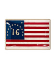 The Faire Betsy Ross American Flag Glass Tray displays a vintage illustration of the original flag—13 stars in a circle, "76" in gold on blue, and bold red and white stripes.