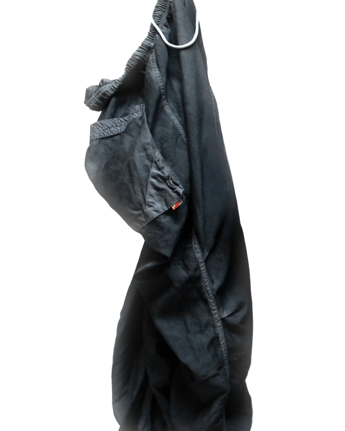 Black satin oversized drawcord lounge pants by Free City on white hanger, relaxed fit.