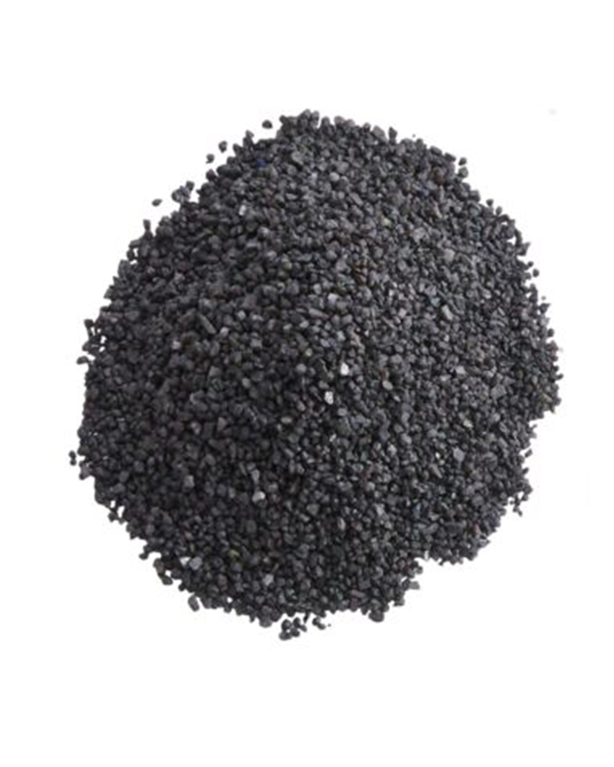 A pile of Accent Decor 22560 Deco Sand, featuring small black granules, is spread out on a white background—ideal for natural-inspired designs.