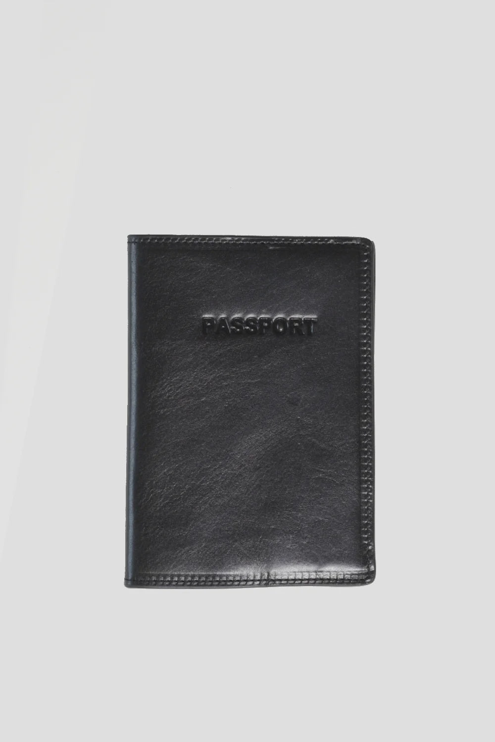 The "Mens Passport Sleeve" by Curated Basics, crafted from Italian leather with the word "PASSPORT" elegantly embossed on the front, is presented against a plain white background.