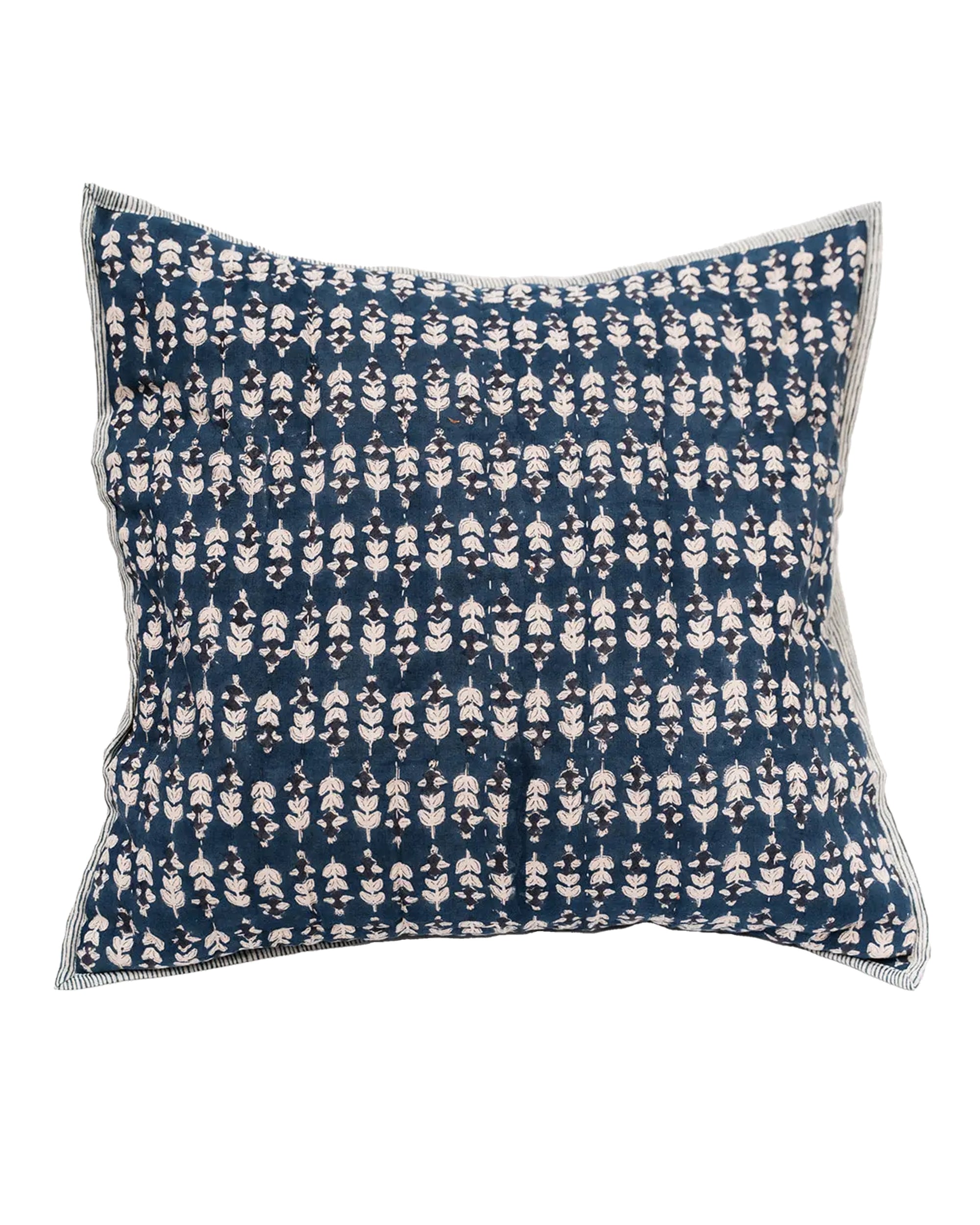 The Faire Blossom Block Print Euro Sham features a dark blue background with small white floral patterns and striped edges—perfect for pairing with block print bedding in a bohemian bedroom decor scheme.