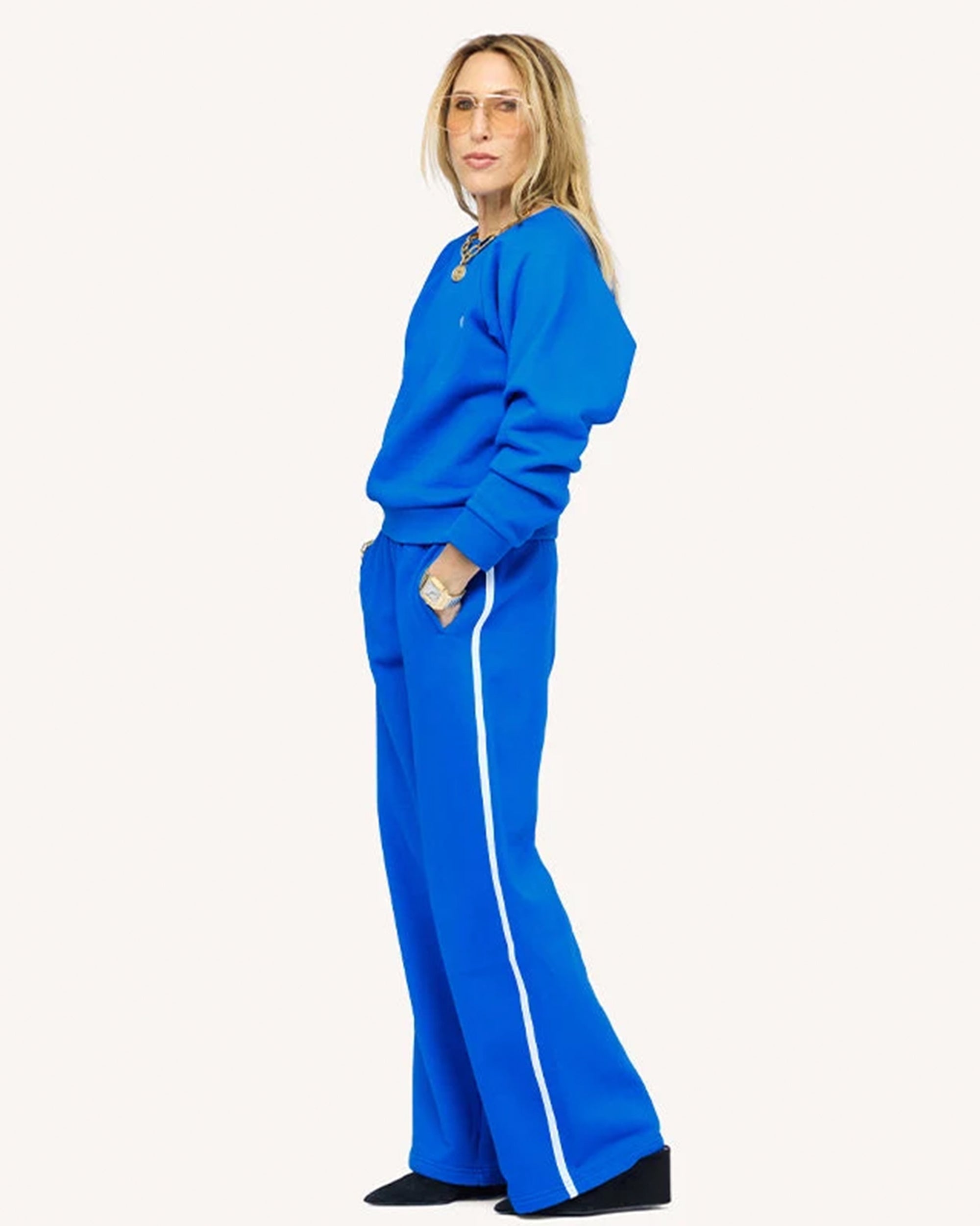 Bright blue fleece Weekend Palazzo pants by Kerri Rosenthal, shown from the side against a white background.