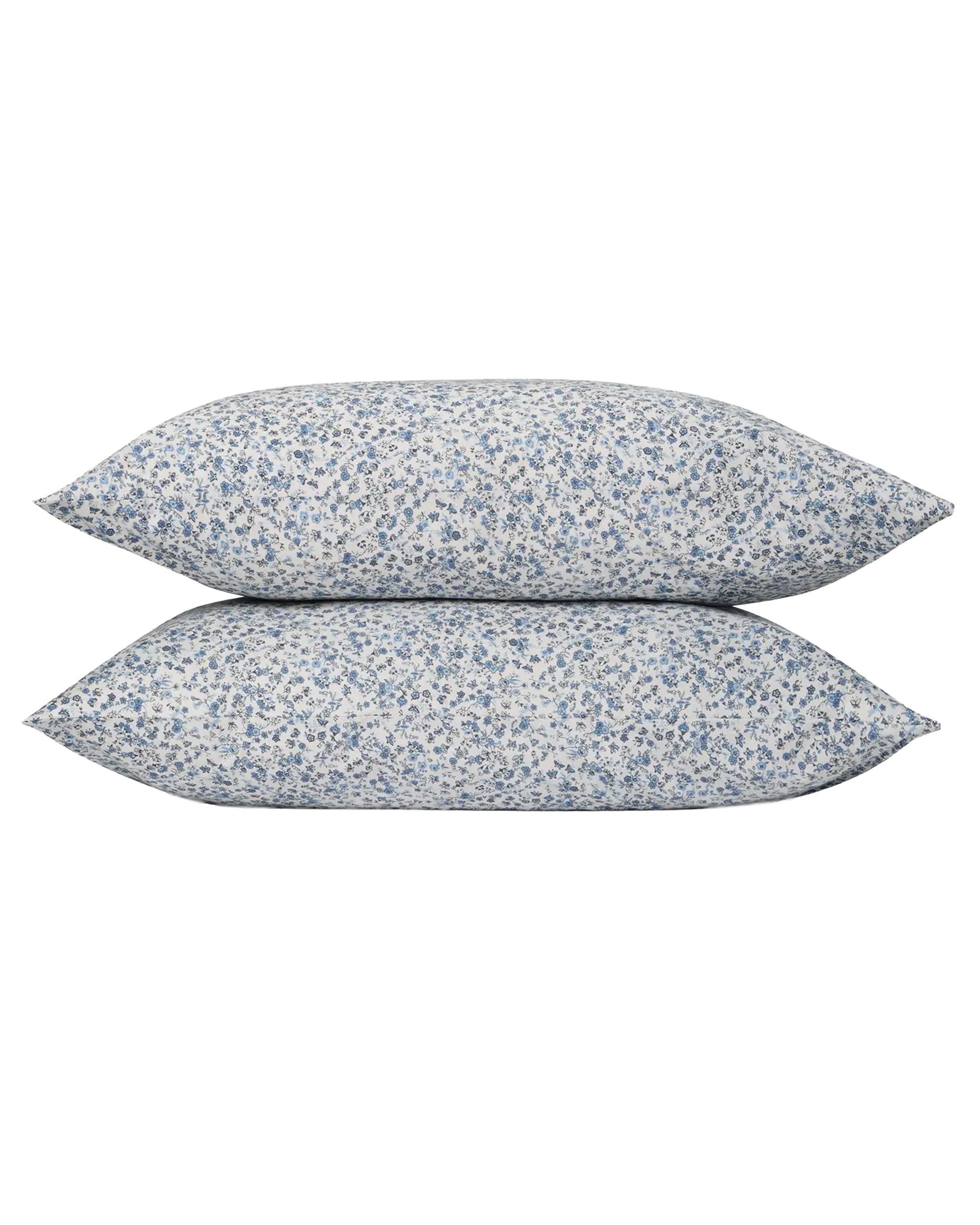 Two Blue Mini Meadow Euro Shams by Faire, featuring a white cover with dense blue vintage florals. Made from 100% cotton percale, these pillowcases offer a soft, cozy, and delicate look.