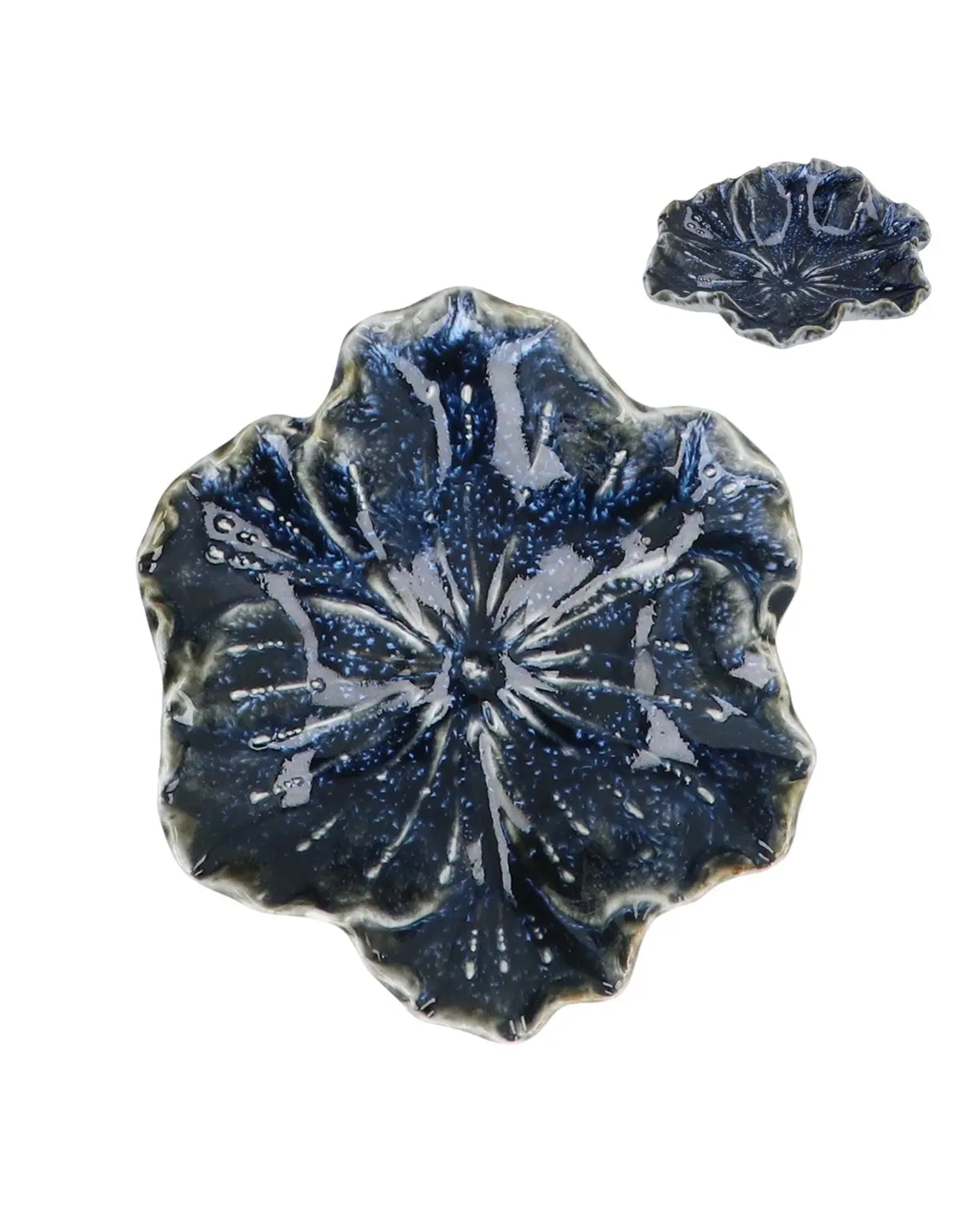 Two Blue Stoneware Hellebore Trinket Dishes by Faire—one large, one small—feature glossy, textured floral shapes, offering elegant home accents reminiscent of the Blue Reactive Stoneware style.