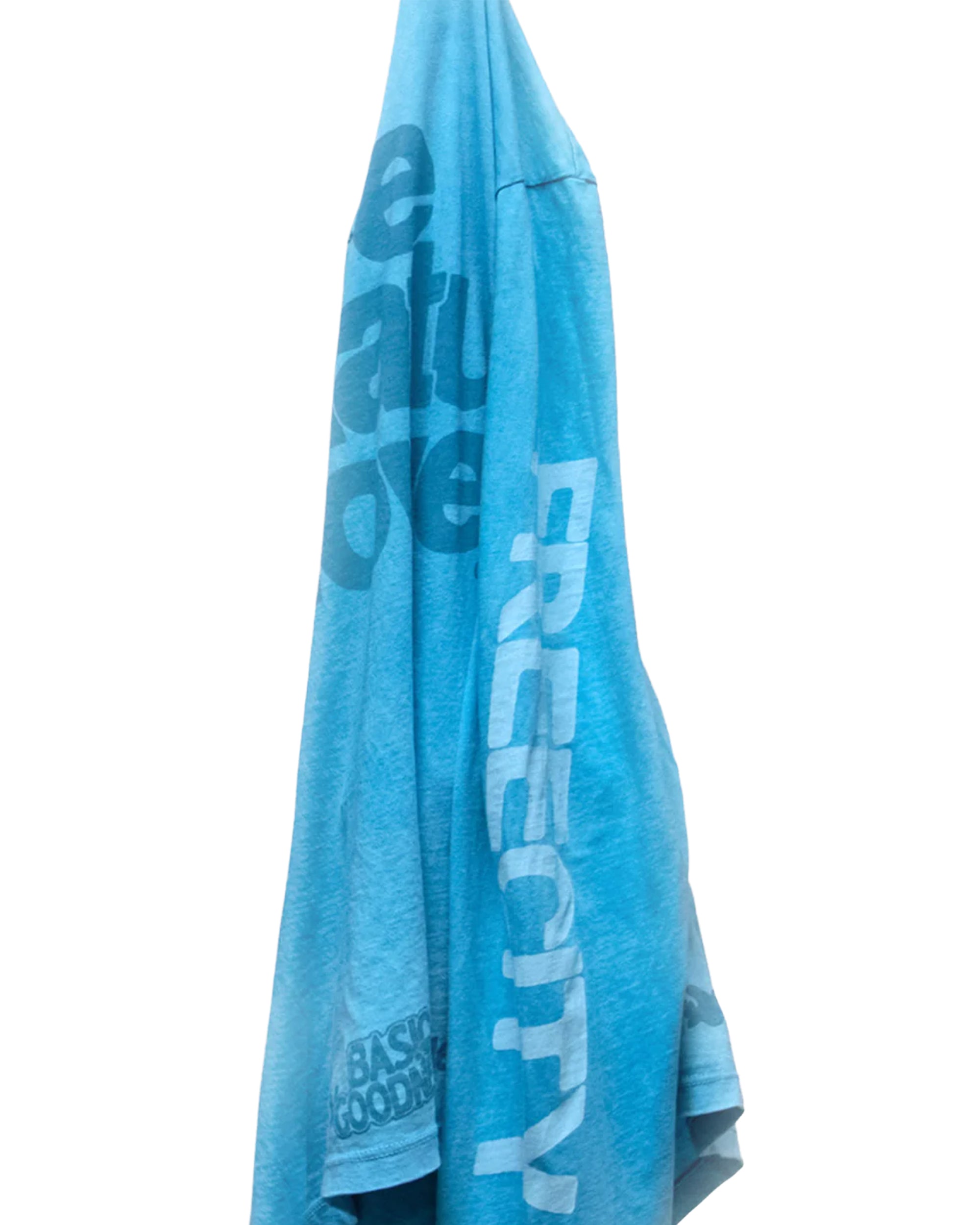A blue LIFENATURELOVE BG LS Tee by Free City (sparrow, LLC) with bold "FREE CITY" text and partially visible letters in dark blue, custom sunfade dye effect, displayed on a white background.