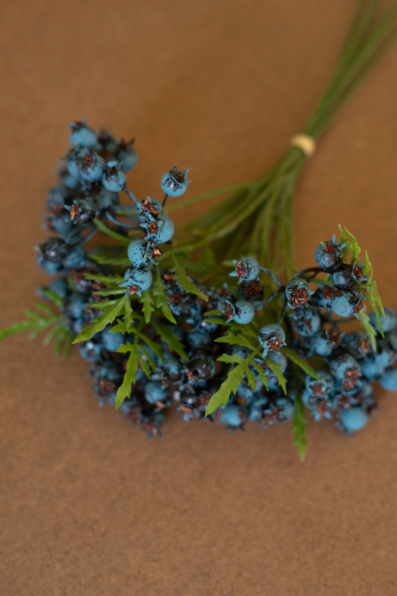 The Kalalou, Inc Blueberry Bundle features artificial berries, green leaves, and long stems tied with a small band, displayed on a brown surface.