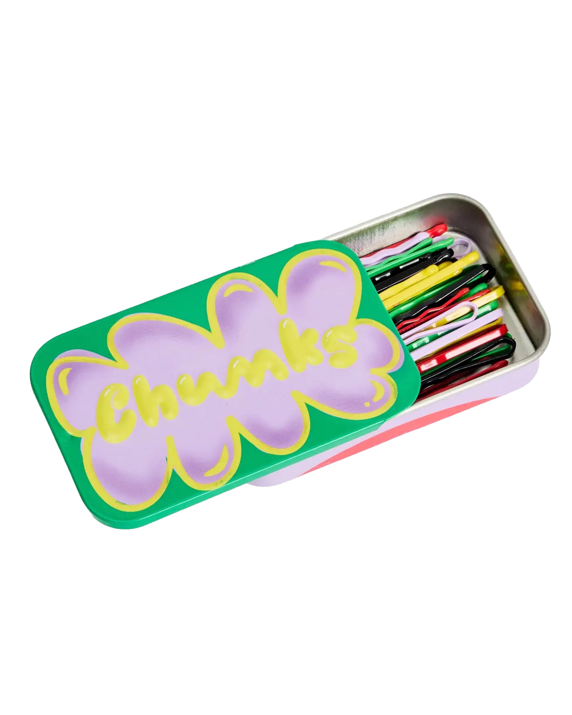 A rectangular reusable metal tin from Faire, labeled "CHUNKS," features a green and purple flower design and is partially open to display CHUNKS Bobby Pins and multicolored hair clips neatly arranged inside.