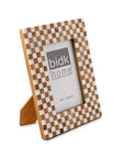 The 4x6 Bone/Wood Frame by BIDK Home features a checkered pattern of light and dark squares, displayed at an angle with a branded placeholder image—an elegant, stylish touch for your home decor.