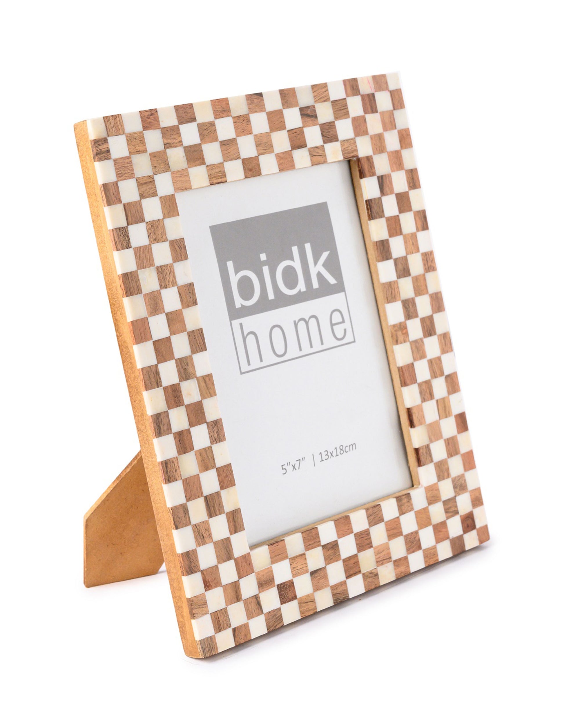 The BIDK Home 5x7 Bone/Wood Frame features a light and dark checkered design, stands upright on a beige support, and is ideal for home décor. It displays a placeholder image with "BIDK Home" and photo size 5"x7" (13x18cm).