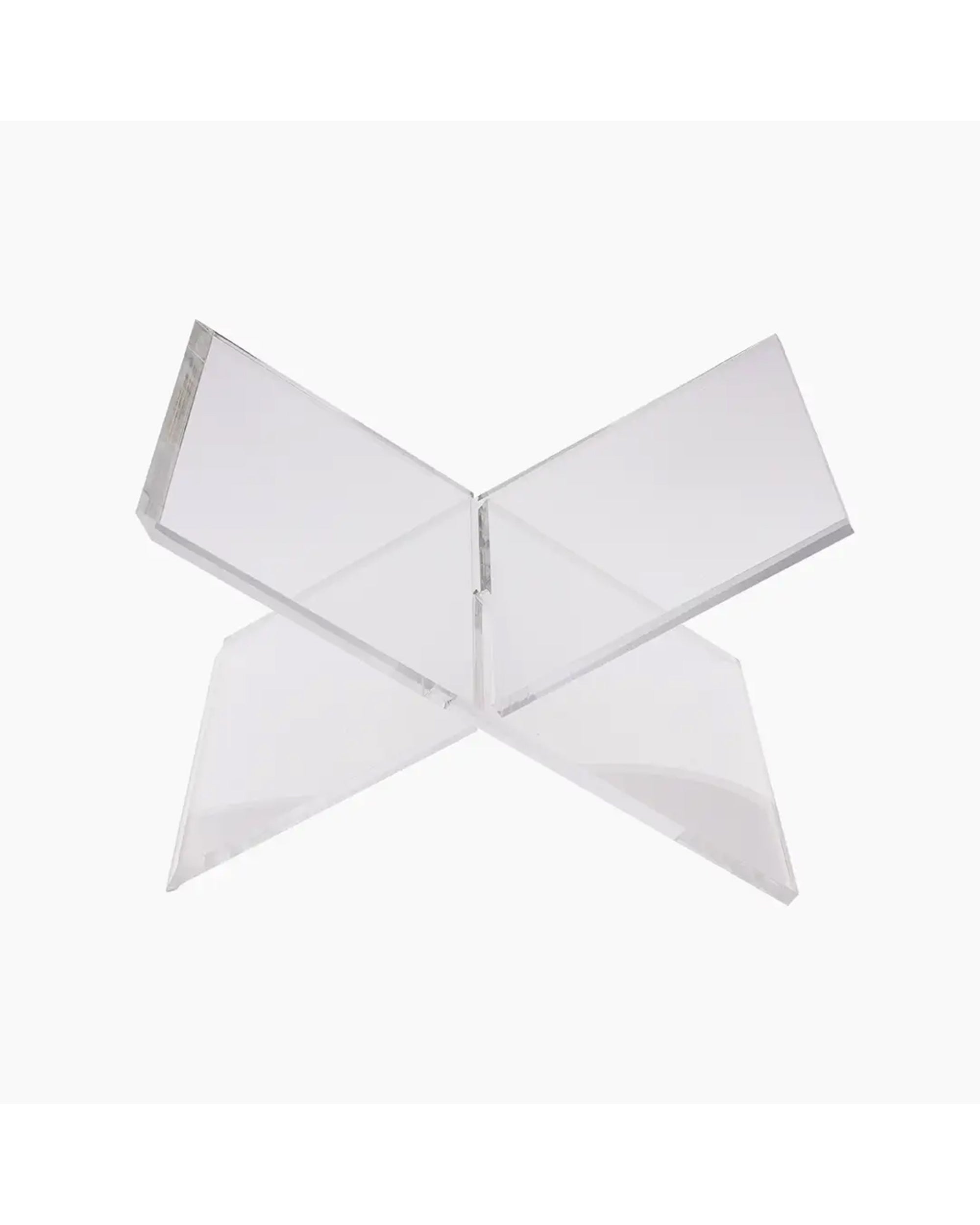 The Faire Acrylic Book Stand Display features two intersecting clear panels forming an X shape, ideal as a modern centerpiece for showcasing your favorite book against any white background.