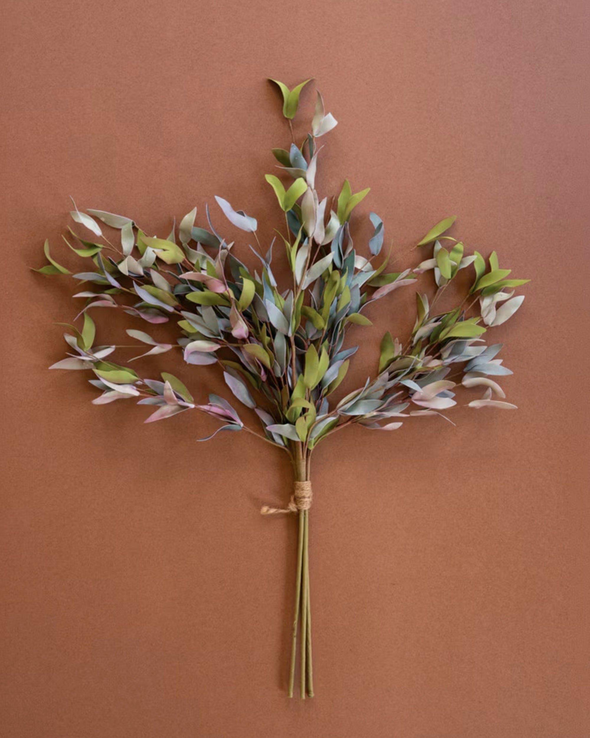 Small faux greenery bunch with twine by Kalalou, displayed on a brown surface.