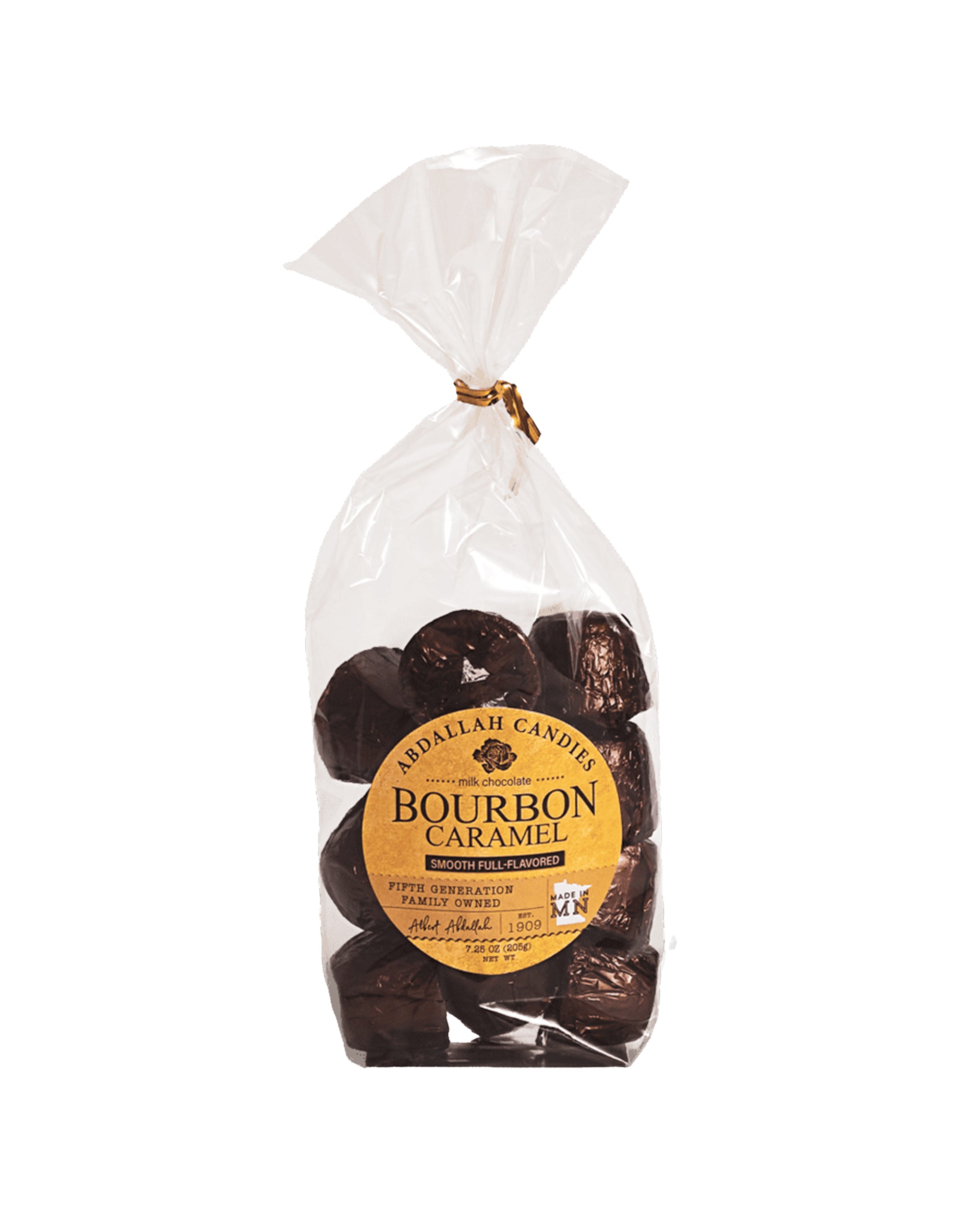 A clear plastic bag of Abdallah Bourbon Caramel Bites, tied with a gold twist and featuring a round yellow label on the front. These gluten-free milk chocolate treats make an irresistible gift.