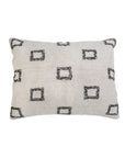 The Bowie Big Pillow by POM POM is a rectangular, cream-colored hand-woven pillow with a textured surface and evenly spaced black, rough-edged square outlines on the front.