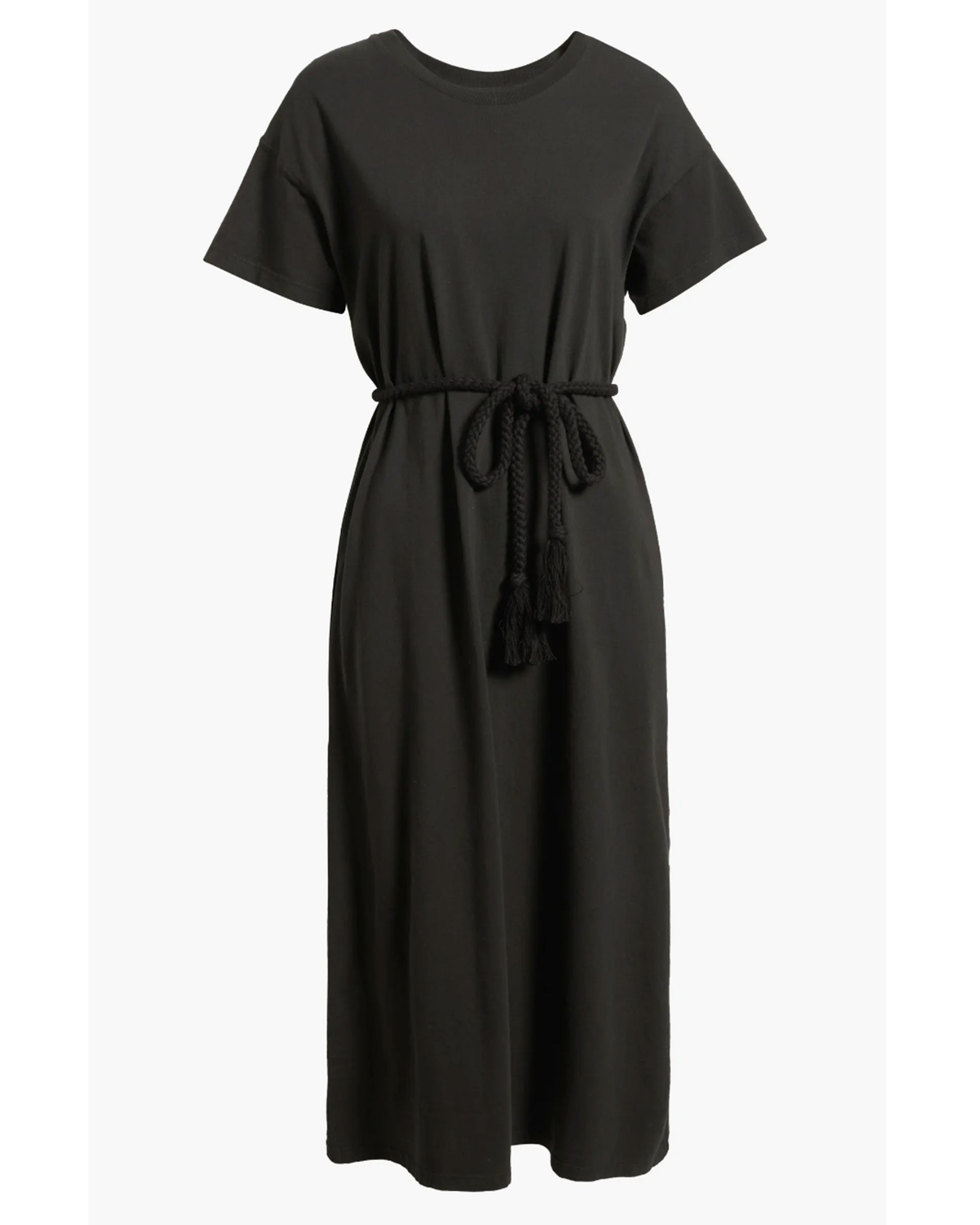 The Boxy Tee Dress by The Great Inc. is a black, short-sleeve, crew neck midi dress with a braided tassel waist tie, crafted from 100% cotton in a T-shirt silhouette and shown against a white background.