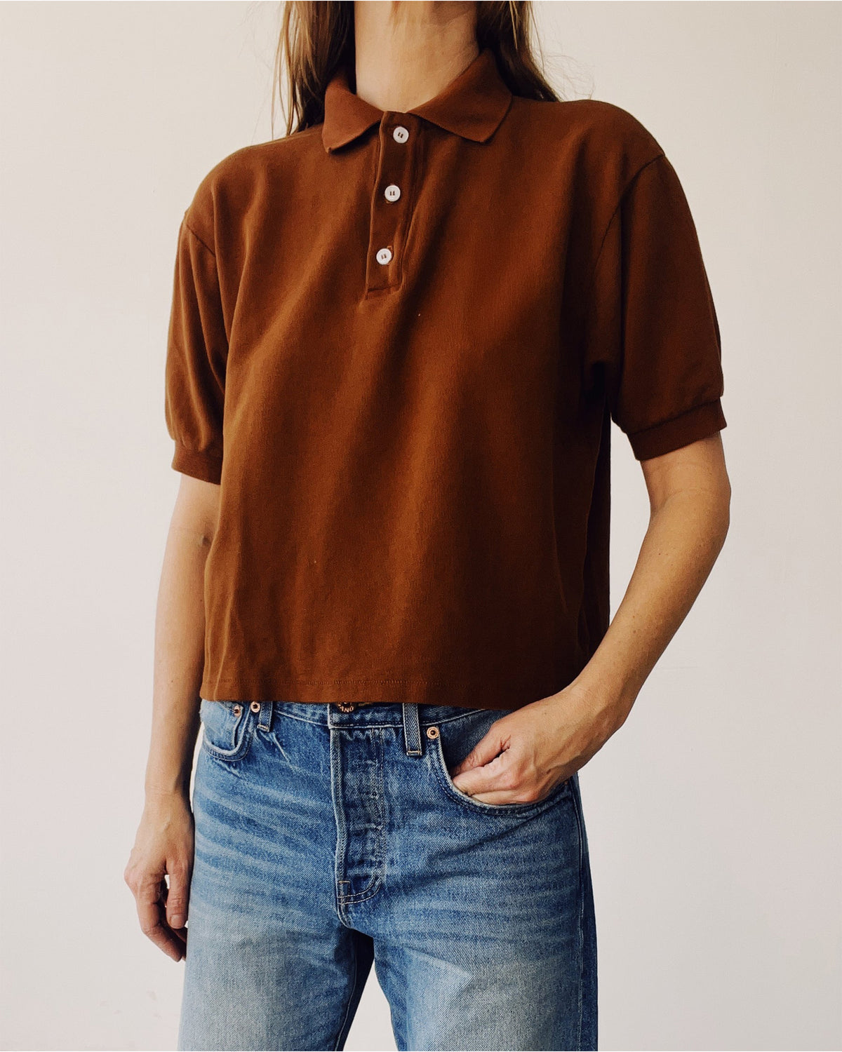 Hey Gang Boxy Polo in Cedar with blue jeans, relaxed fit, modeled against a simple light backdrop.