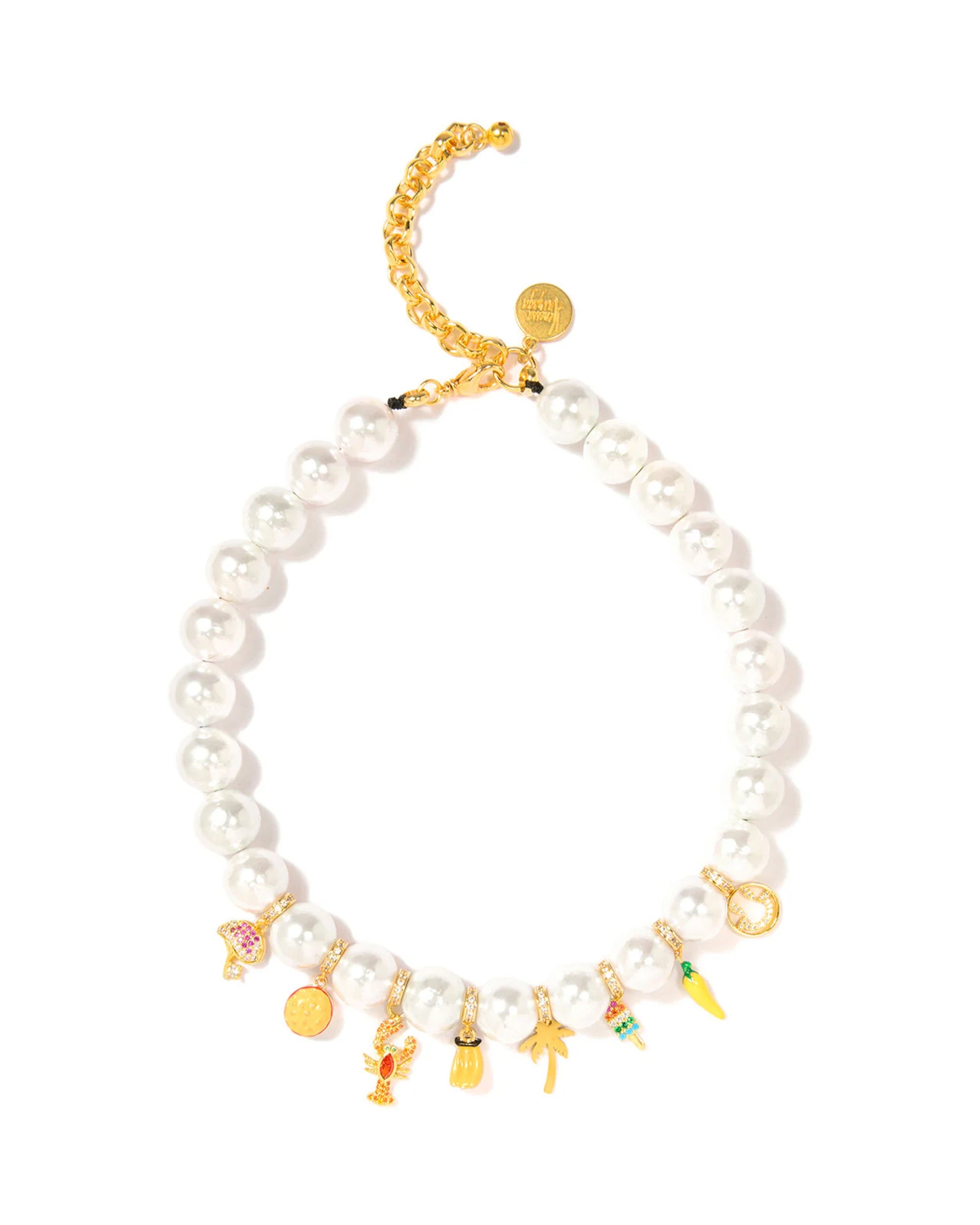 The Brunch by the Sea Necklace 16" by Venessa Arizaga features large white shell pearls with a gold adjustable chain and whimsical gold and colorful charm pendants shaped like mushrooms, animals, and other playful objects.