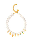 The Brunch by the Sea Necklace 16" by Venessa Arizaga features large white shell pearls with a gold adjustable chain and whimsical gold and colorful charm pendants shaped like mushrooms, animals, and other playful objects.