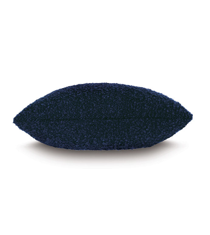 The MARL DECO IN INDIGO by Eastern Accents is a rectangular, dark blue decorative pillow with a soft, boucle-like texture and slightly pointed corners, shown against a plain white background.