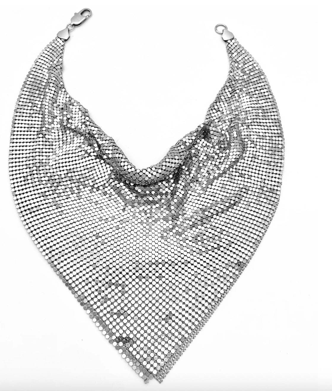 The Faire Chain Mail Bandana Scarf Necklace showcases a vintage silver mesh in a triangular, chainmail-style design with a shiny finish, making a bold statement. It is displayed on a white background.