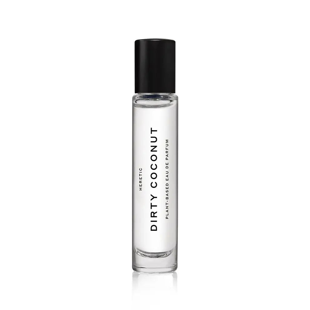 A clear glass bottle with a black cap, labeled "Heretic 15ML Perfume" and "Faire" in black text, stands upright on a white background—an elegant fragrance with plant-based sandalwood vanilla notes.