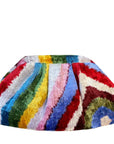 The Faire Silk Velvet Ikat Soft Clutch features colorful pleated velvet with vibrant wavy stripes—an elegant accessory that adds a touch of luxury to any look.