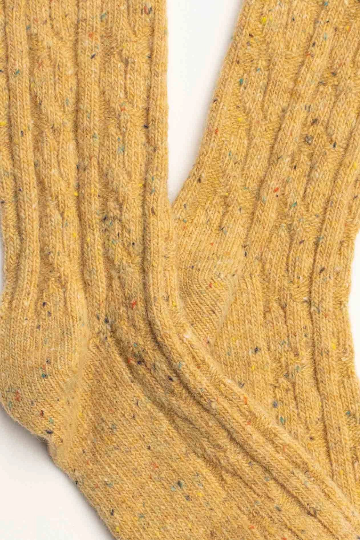 Close-up of Faire&#39;s Wool Speckled Knit Socks in yellow, showcasing a cozy textured wool-blend with multicolored specks throughout.