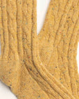 Close-up of Faire's Wool Speckled Knit Socks in yellow, showcasing a cozy textured wool-blend with multicolored specks throughout.
