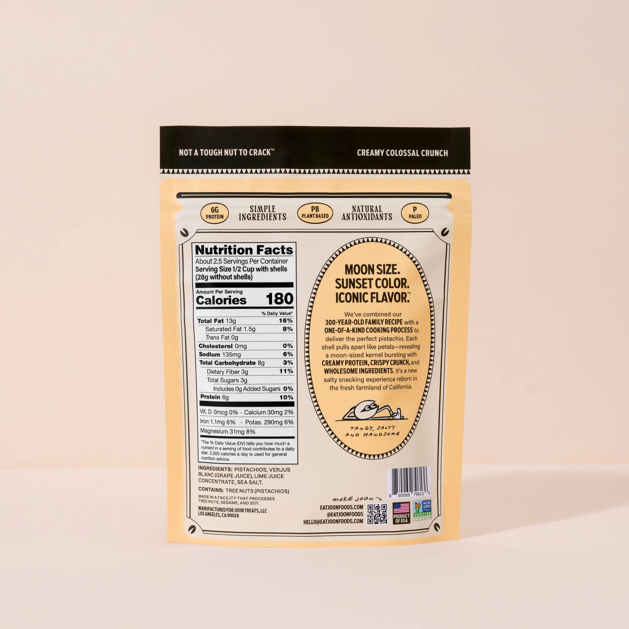 Back of a yellow Faire Joon Pistachios package showing nutrition facts, ingredients, and product info. Highlights simple ingredients, natural antioxidants, creamy colossal crunch—making it the perfect healthy snack.