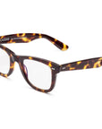 Tortoiseshell rectangular Caddis Porgy Backstage glasses feature clear magnification lenses, thick premium acetate frames, subtle silver accents by the hinges, and "Caddis" labeled inside the left arm.