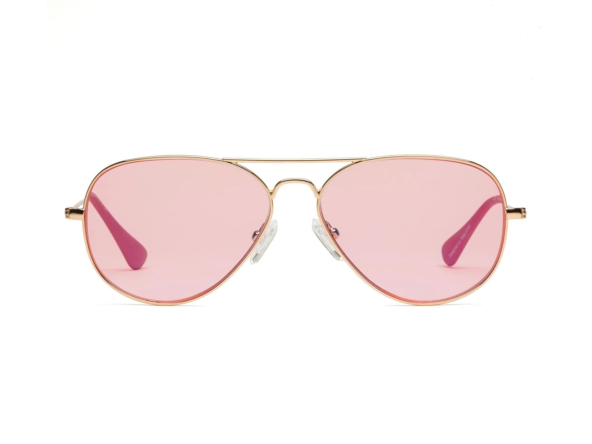 The Caddis Mabuhay Polished Gold aviator sunglasses feature thin gold frames, light pink tinted lenses, and comfortable rubber temple tips, displayed against a plain white background.