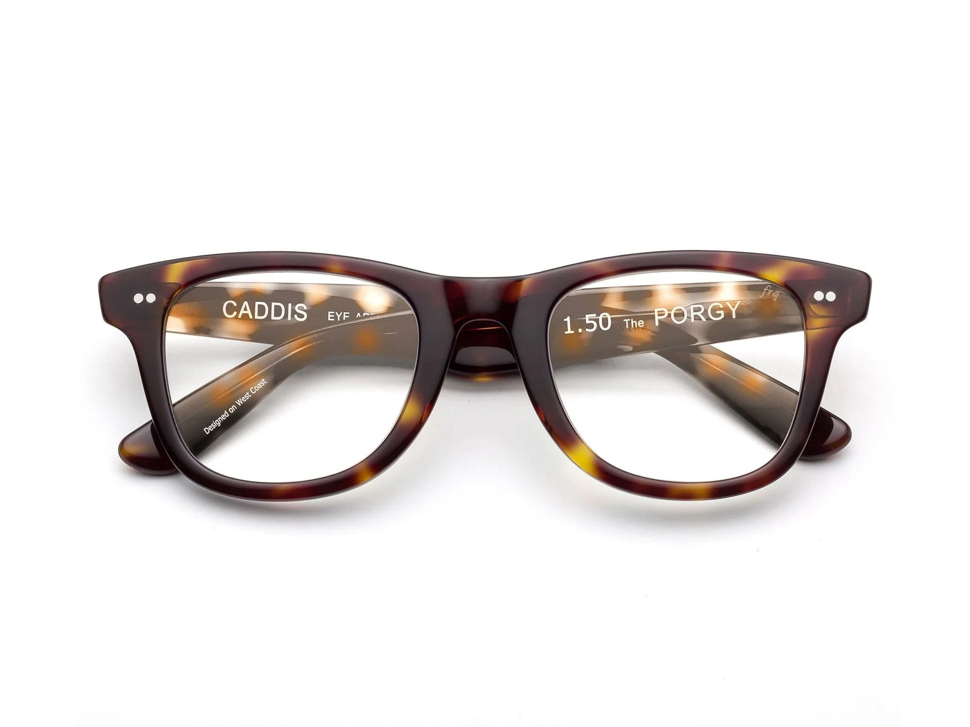 The Caddis Porgy Backstage glasses feature thick, rounded tortoiseshell acetate frames and clear 1.50 magnification lenses. “1.50 The PORGY” appears on the right lens, with “CADDIS” on the left inner arm.