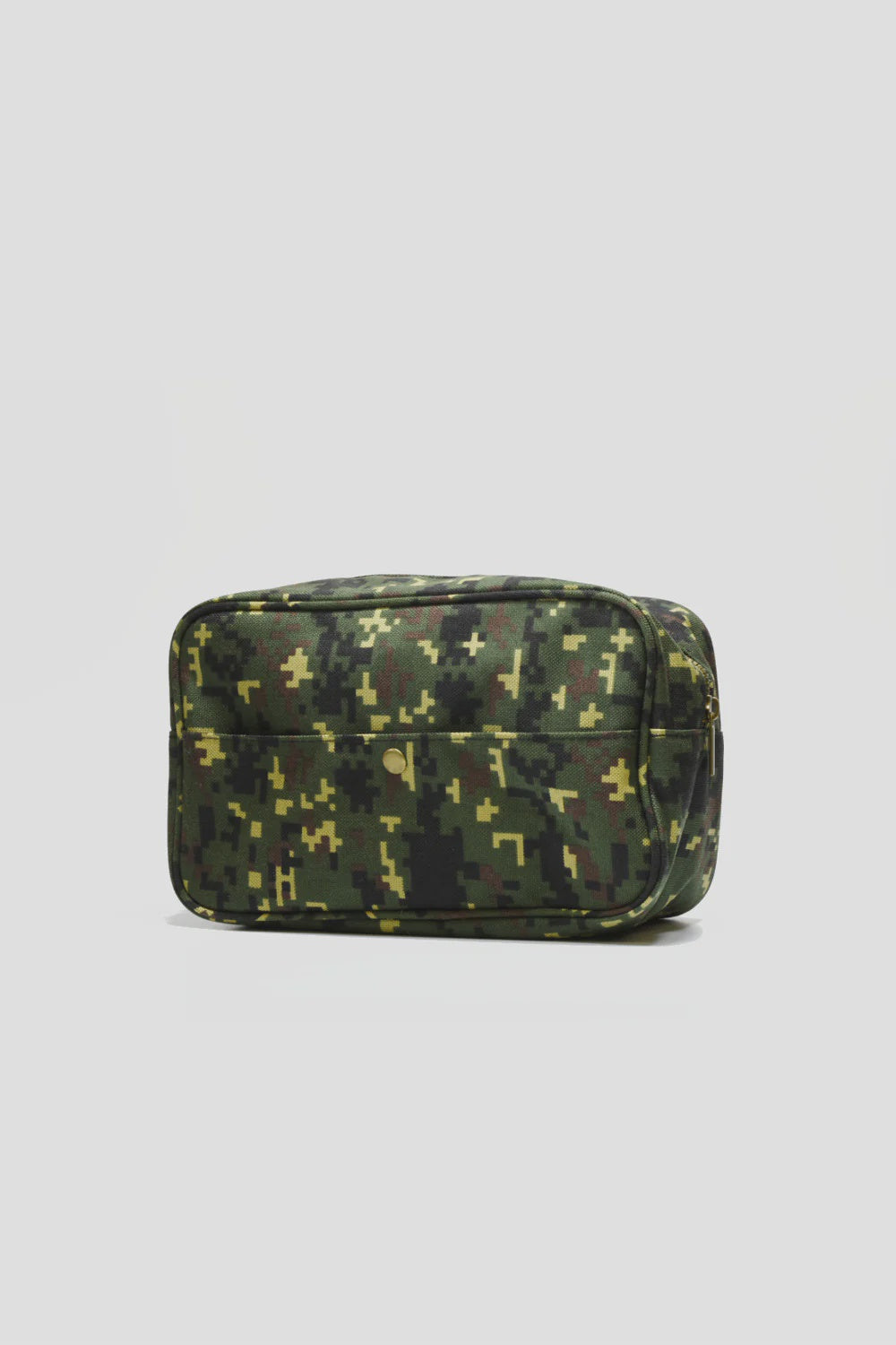 The MENS Digital Camo Dopp Kit by Curated Basics is a compact rectangular bag adorned with a digital camouflage pattern in shades of green, black, and brown. It is crafted from durable nylon with a sleek brass zipper closure on top and an additional front pocket. The bag's background color is plain light gray.