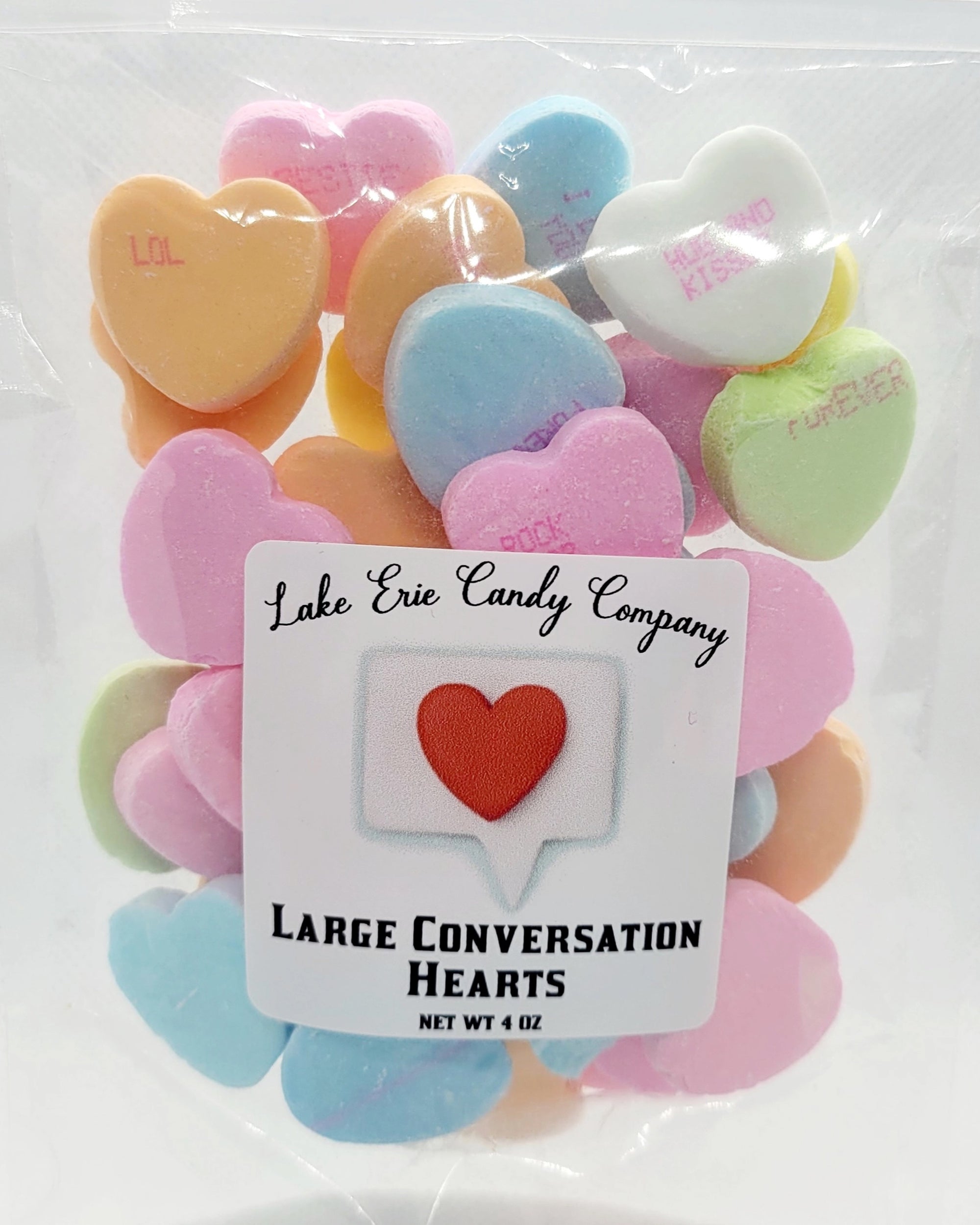 A clear bag labeled "Lake Erie Valentine Candy" by Faire contains colorful heart-shaped candies with sweet messages—perfect for Valentine’s Day treats.